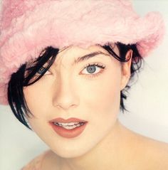 a close up of a person wearing a pink hat