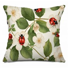 a white pillow with ladybugs and flowers on it