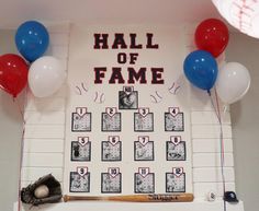 a baseball themed hall of fame display with balloons and decorations on the wall above it