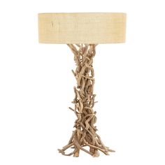 a table lamp made out of driftwood with a beige shade on the top and bottom