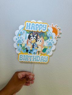 someone holding up a happy birthday cake topper with the characters from cartoon network on it