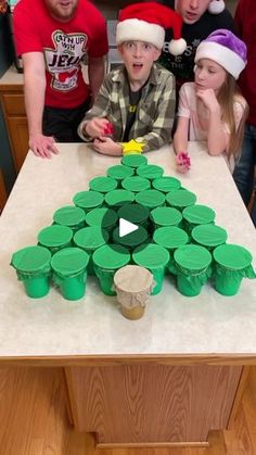 a group of kids sitting around a table with cupcakes