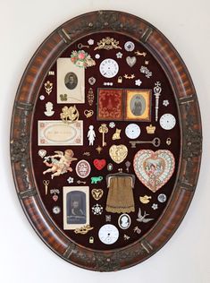 a wall mounted clock with lots of different items on it's face and sides