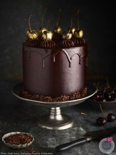 a chocolate cake with cherries on top