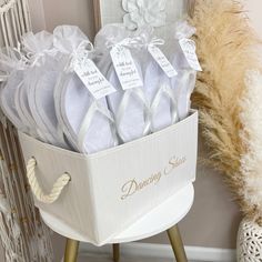 a basket filled with white shoes sitting on top of a table