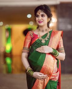 a woman in an orange and green sari