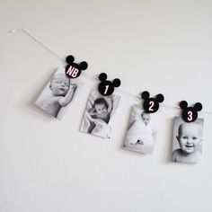 a mickey mouse photo hanging on a string with three photos attached to it and the number two