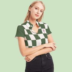 a woman in a green and white shirt is standing with her arms crossed on her chest