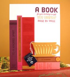 a stack of books sitting next to each other on top of a book case with a tag