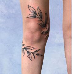 a woman's leg with leaves on it