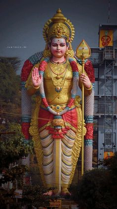 a large statue of the hindu god in front of a building