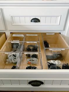 the drawers are filled with electronics and cords