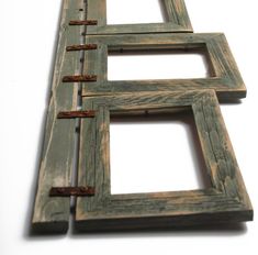 three wooden frames are stacked on top of each other to form the shape of a rectangle