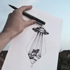 a hand holding a piece of paper with an image of a dog in the sky