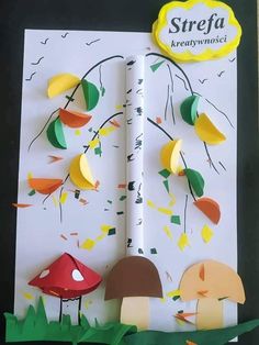 the paper is cut out to look like mushrooms and trees with yellow leaves on them