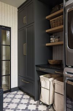 a kitchen with black cabinets and white checkered flooring