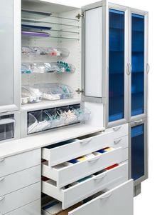 an open medicine cabinet with many drawers