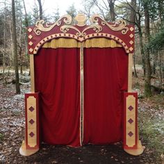 a red and gold stage set in the woods