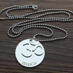 Om Disc Yoga Name Necklace Sterling Silver - Get inner peace and tranquility when you wear our Om Disc Name Necklace . This beautiful yoga necklace comes with an om charm and an engraved disc. Choose one of our proposed words, or engrave any name or word you want on this om necklace. Need a good gift for someone into yoga and empowerment? This om pendant necklace is the perfect choice. Item specifics: Style Name Necklace/Love Necklace Pendant Size 2.5cm/1" Hook Single Hook Material Sterling Silv Spiritual Personalized Medallion Charm Necklaces, Spiritual Personalized Medallion Charm Necklace, Personalized Silver Necklace For Meditation, Spiritual Personalized Necklaces, Spiritual Engraved Charm Necklaces For Personalized Gift, Spiritual Engraved Charm Necklace For Personalized Gift, Engraved Spiritual Charm Necklaces For Personalized Gifts, Personalized Spiritual Charm Necklace With Round Pendant, Spiritual Personalized Round Pendant Charm Necklace