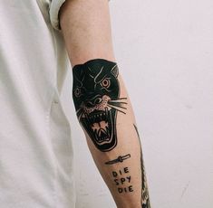 a man's arm with a black panther tattoo on it and the words die spy die