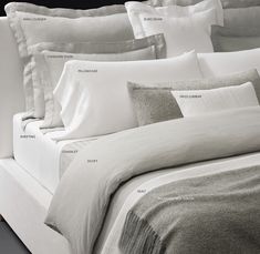 an image of a bed with white sheets and pillows