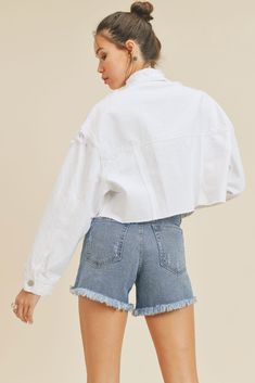 Our White Distressed Jean Jacket is designed with a shorter length, dropped shoulders, and a raw hem for a contemporary style. Its rugged look adds edge to any outfit without sacrificing comfort. Front button placket Button cuffs Distressed detail 100% Cotton Designed in the US by JBD Size Guide Loose fit 15" CF, 4.5" SIDESEAM, 45.5" SWEEP The model is wearing a size Small Cropped Cotton Jacket With Frayed Hem, Chic Cotton Outerwear With Frayed Hem, Cropped Outerwear With Frayed Hem For Fall, Relaxed Fit Button-up Outerwear With Frayed Hem, Winter Outerwear With Frayed Hem And Relaxed Fit, Frayed Hem Cropped Jacket For Fall, White Denim Jacket With Frayed Hem For Fall, Casual White Outerwear With Frayed Hem, Fall Cropped Jacket With Frayed Hem