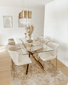 a dining room table with chairs and a chandelier