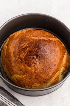 a loaf of bread sitting in a pan on top of a table