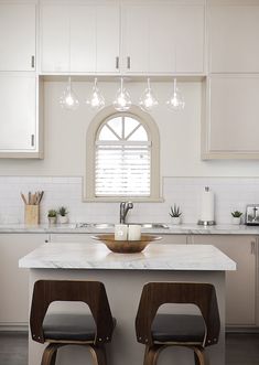 two stools sit in front of a kitchen island