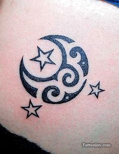 a woman's stomach with stars and crescent tattoo on it