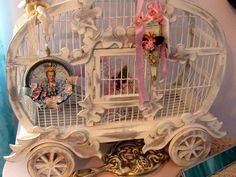 a white birdcage sitting on top of a table