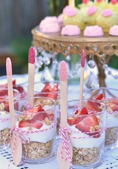 baby shower desserts with strawberries and cupcakes in the middle on a table