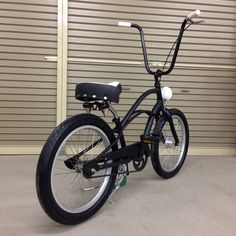 a black bicycle parked in front of a garage door