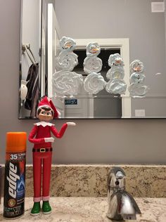 an elf is standing in front of a bathroom mirror next to a spray bottle and toilet paper