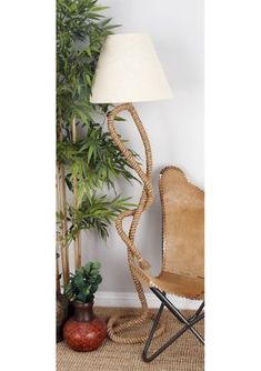 a chair next to a lamp and potted plants