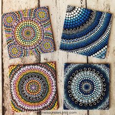 four coasters made out of bead work on wooden boards, each with different designs