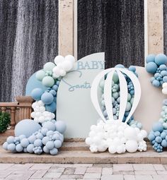 a baby shower is set up with balloons and streamers