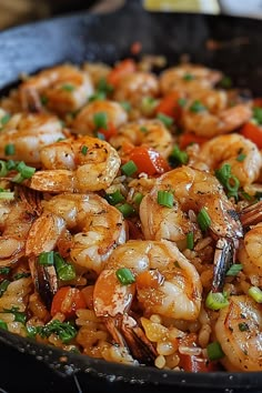 a skillet filled with shrimp and vegetables