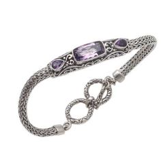 Totaling over four carats two teardrops of faceted amethyst flank a majestic rectangle. Balinese artisan Kadek Hendra crafts this bracelet from sterling silver showcasing intricate patterns in a combination of finishes. This bracelet circles the wrist with sterling foxtail chain closing with a toggle clasp. Luxury Rectangular Amethyst Jewelry, Elegant Sterling Silver Amethyst Bracelet, Elegant Amethyst Rectangular Stone Jewelry, Elegant Sterling Silver Amethyst Gemstone Bracelet, Elegant Amethyst Jewelry With Rectangular Stone, Amethyst Color, Amethyst Pendant, Bracelet Crafts, Balinese