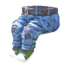 a pair of blue jeans with a flower on the bottom and one leg in the shape of a boot