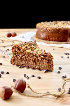 a piece of cake sitting on top of a wooden table next to an acorn