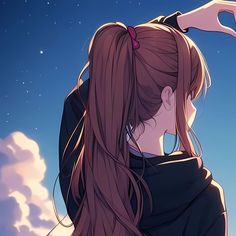 a girl with long hair is looking up at the sky