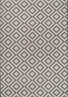 a gray and white rug with diamond shapes on it