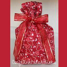 a red gift bag with hearts on it