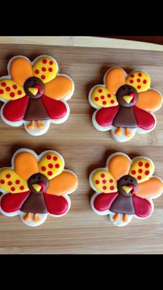 four decorated cookies in the shape of turkeys