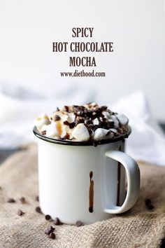 hot chocolate mocha in a white mug with whipped cream and chocolate chips on top