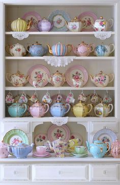 a china cabinet filled with lots of different colored dishes