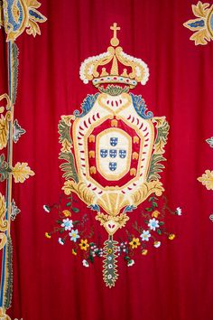 a red curtain with gold and blue designs on it