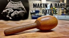 a wooden mallet sitting on top of a table next to an image of a baby