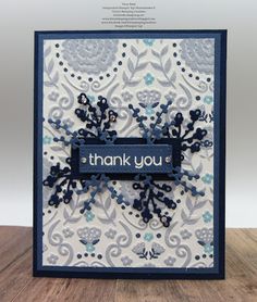 a thank you card with blue and white flowers on the front, and an embellishment that says thank you